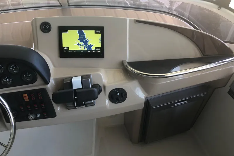 Slide: The Image of 2005 Carver 41 Cockpit Motor Yacht helm with navigation screen and controls. - 32
