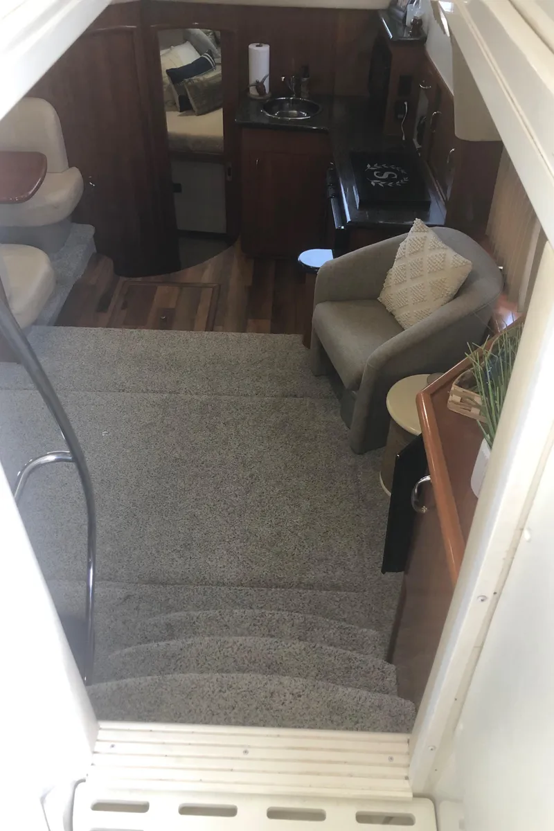 Slide: The Image of Interior of 2005 Carver 41 Cockpit Motor Yacht with carpeted stairs and cozy seating. - 35