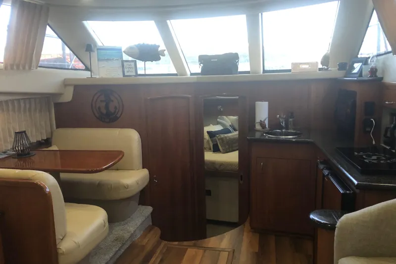 Slide: The Image of Interior of 2005 Carver 41 Cockpit Motor Yacht with dining area and kitchen. - 38