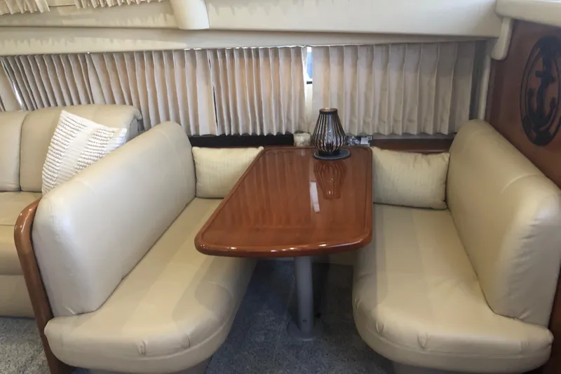 Slide: The Image of Interior seating area of 2005 Carver 41 Cockpit Motor Yacht with beige leather upholstery. - 43