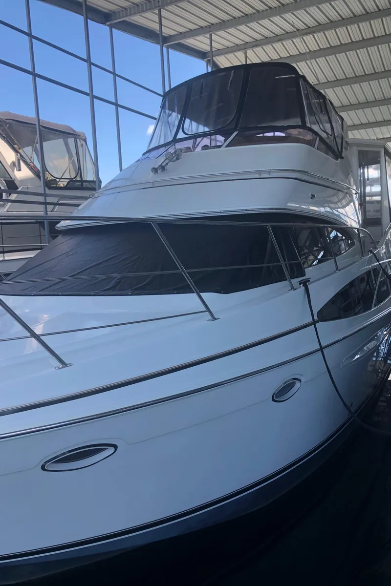 Slide: The Image of 2005 Carver 41 Cockpit Motor Yacht in a covered marina. - 5