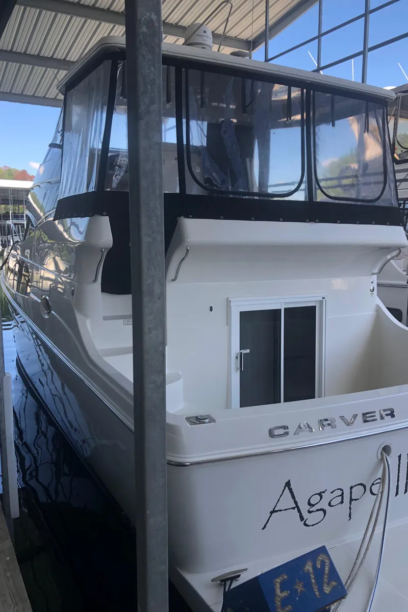 Slide: The Image of 2005 Carver 41 Cockpit Motor Yacht docked in a marina. - 6