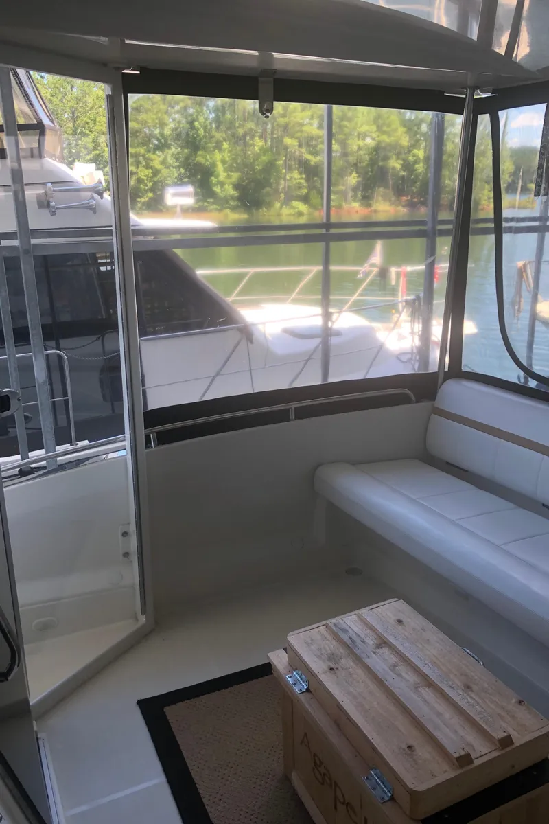 Slide: The Image of 2005 Carver 41 Cockpit Motor Yacht interior with seating and lake view. - 13