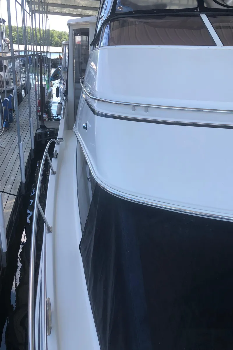 Slide: The Image of 2005 Carver 41 Cockpit Motor Yacht docked at marina. - 22