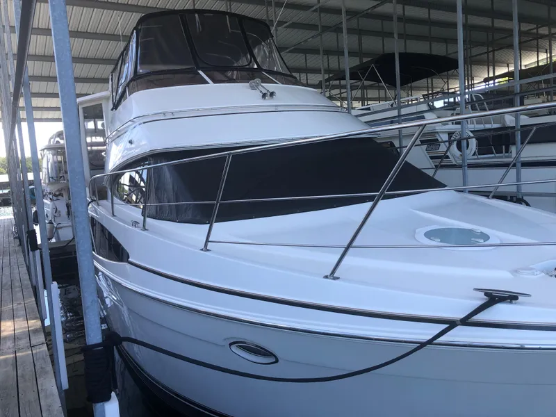Slide: The Image of 2005 Carver 41 Cockpit Motor Yacht docked in a covered marina. - 3