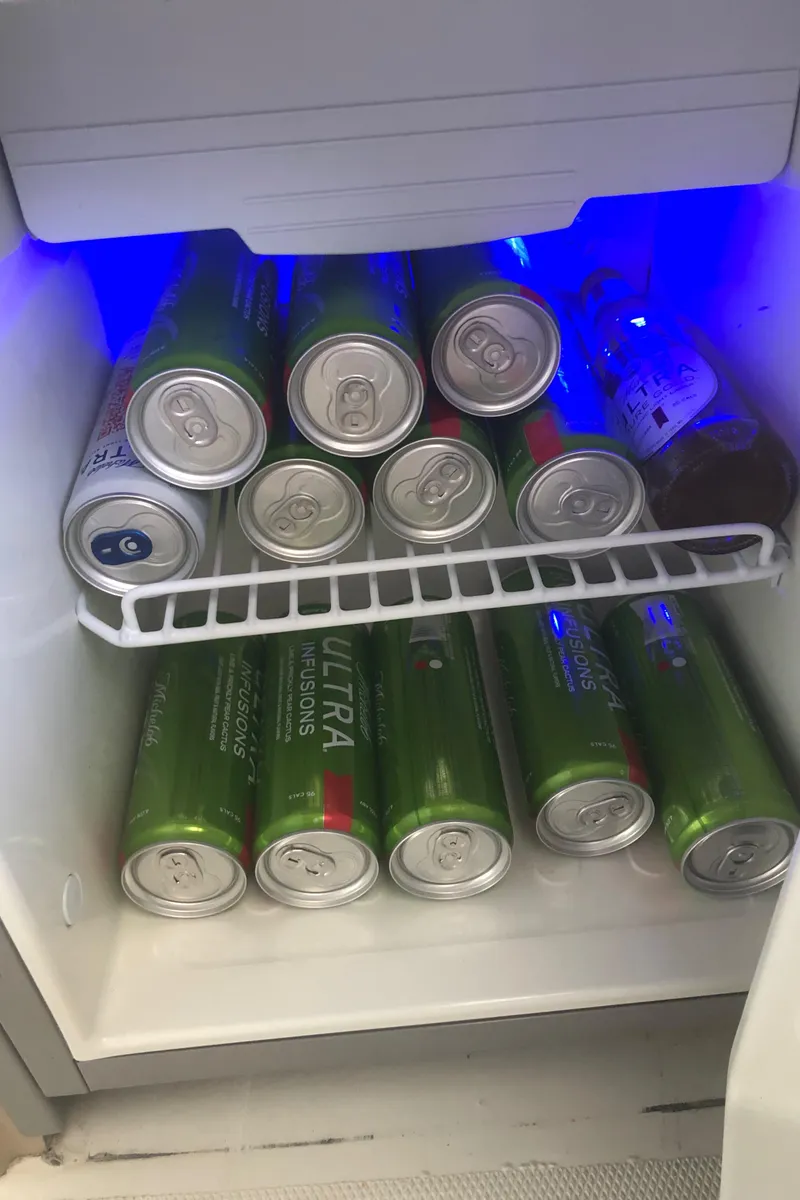 Slide: The Image of Mini fridge stocked with beverages on a 2005 Carver 41 Cockpit Motor Yacht. - 30