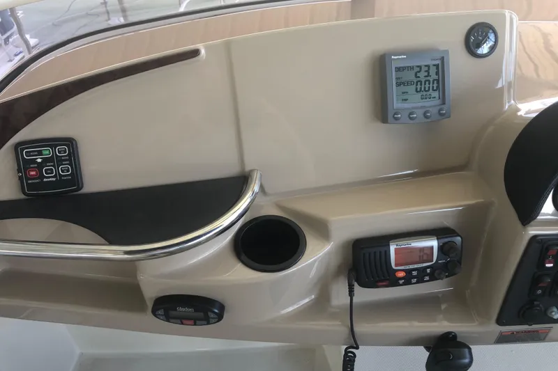 Slide: The Image of 2005 Carver 41 Cockpit Motor Yacht helm with navigation instruments and controls. - 31