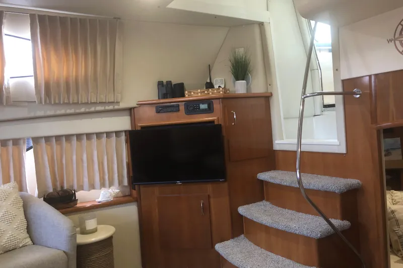 Slide: The Image of Interior of 2005 Carver 41 Cockpit Motor Yacht with TV, stairs, and cozy seating area. - 36