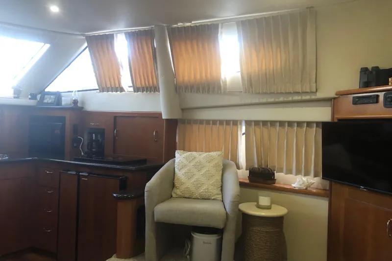 Slide: The Image of Interior of 2005 Carver 41 Cockpit Motor Yacht with kitchen and seating area. - 37