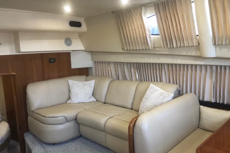 Slide: The Image of Interior of 2005 Carver 41 Cockpit Motor Yacht with beige leather seating and curtains. - 40