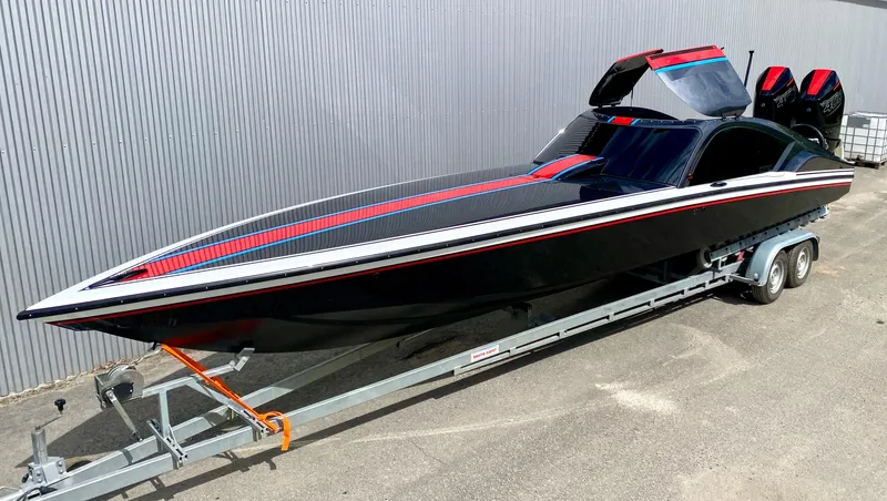 The Image of 2024 Nitra Boats 30 SkyTop on trailer, sleek black and red design. - 1