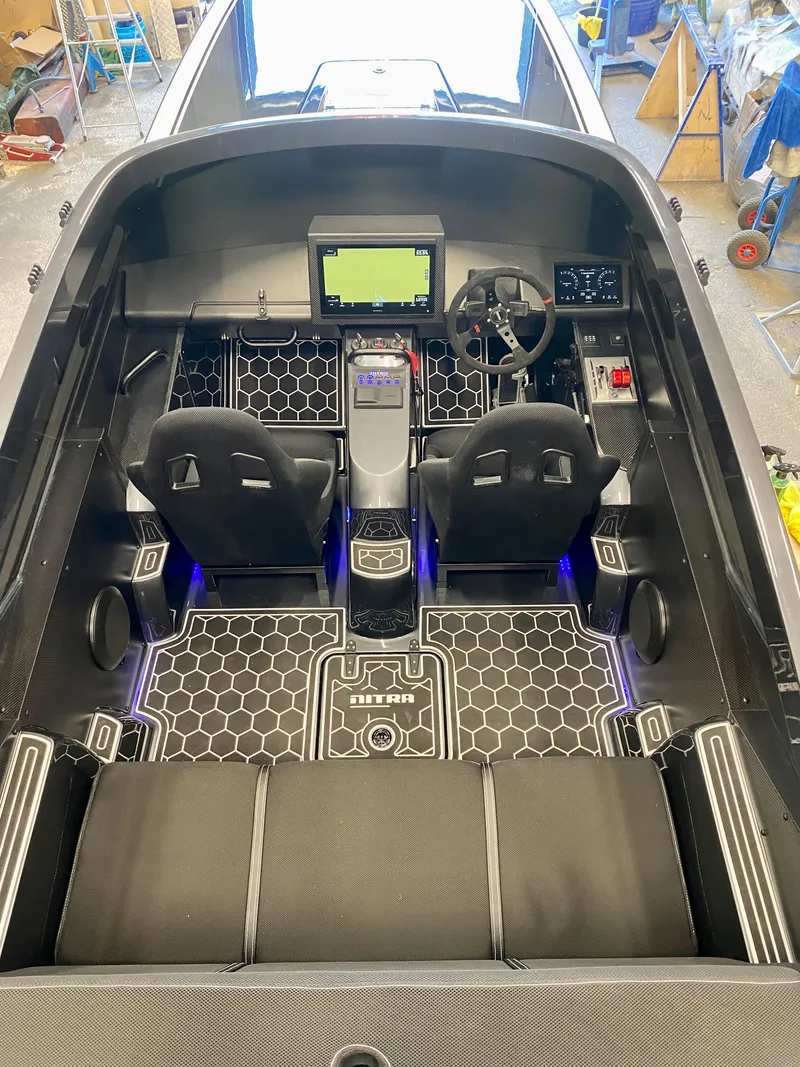 Slide: The Image of 2024 Nitra Boats 30 SkyTop cockpit with modern dashboard and dual seating. - 11