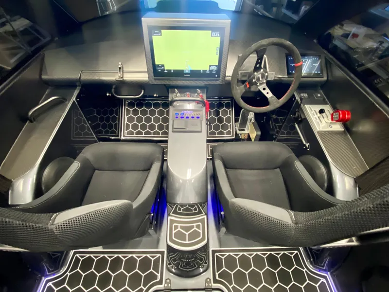 Slide: The Image of 2024 Nitra Boats 30 SkyTop cockpit with dual seats, advanced navigation system, and modern controls. - 13