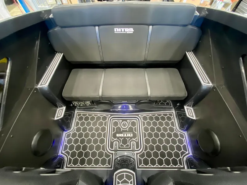 Slide: The Image of 2024 Nitra Boats 30 SkyTop interior with black seating and hexagonal floor design. - 16