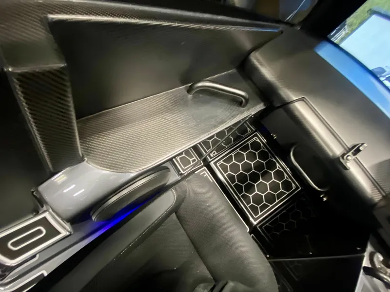 Slide: The Image of Interior of 2024 Nitra Boats 30 SkyTop with sleek, modern design and carbon fiber accents. - 18