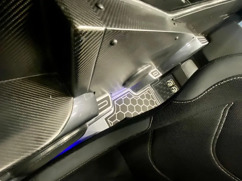 Slide: The Image of 2024 Nitra Boats 30 SkyTop interior with carbon fiber detailing and illuminated floor. - 20