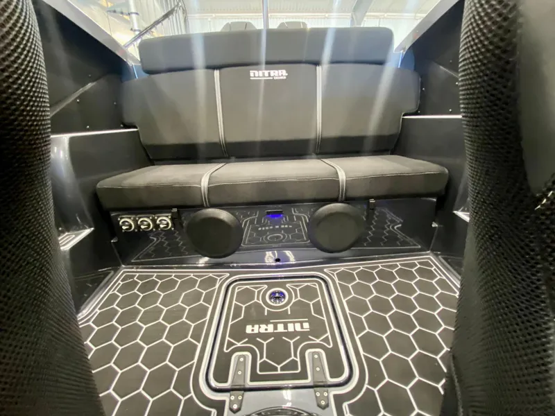 Slide: The Image of Interior of 2024 Nitra Boats 30 SkyTop with black seating and hexagonal floor design. - 21