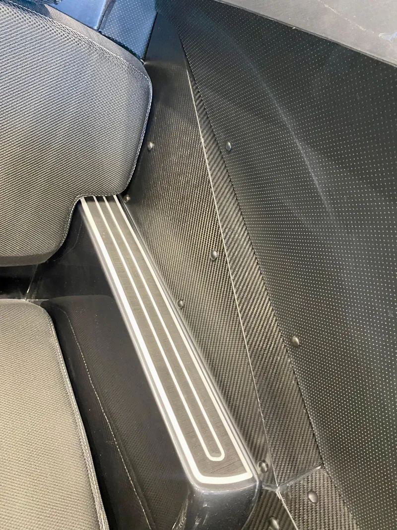 Slide: The Image of Interior detail of 2024 Nitra Boats 30 SkyTop, featuring sleek carbon fiber finish. - 26