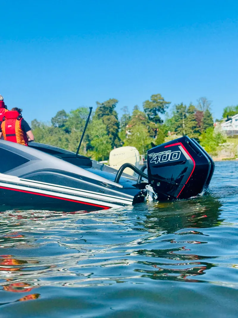 Slide: The Image of 2024 Nitra Boats 30 SkyTop on a lake with a powerful outboard motor. - 6