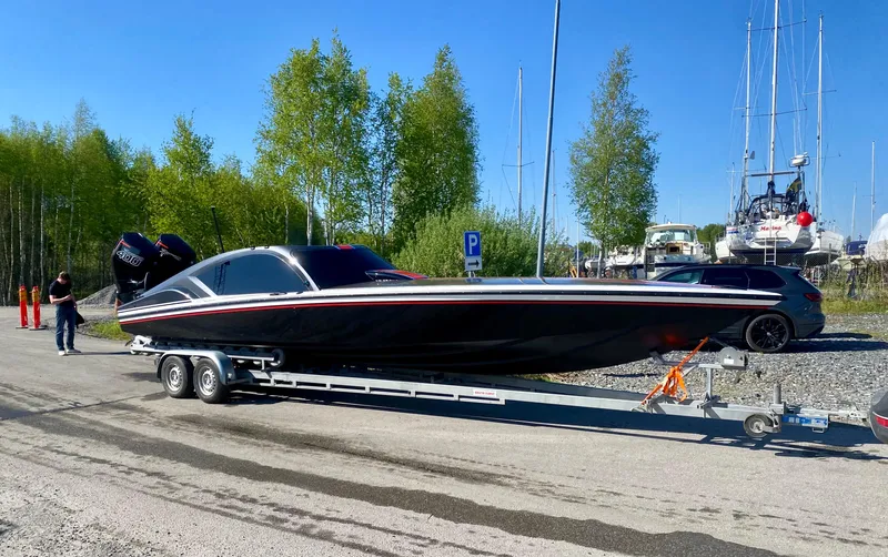 Slide: The Image of 2024 Nitra Boats 30 SkyTop on trailer, parked near marina. - 9