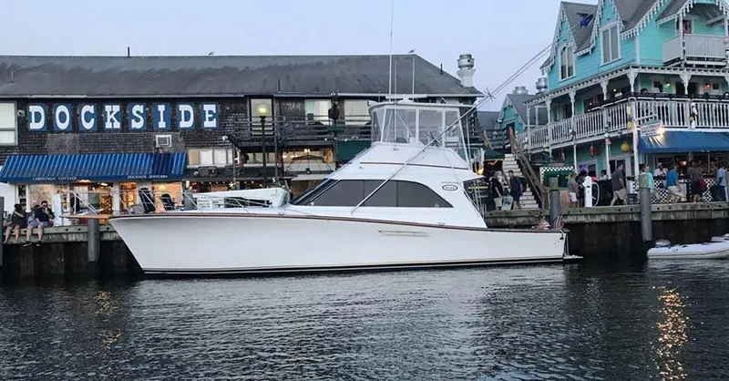 The Image of 1989 Ocean Yachts 44 Super Sport Custom docked near waterfront buildings. - 0