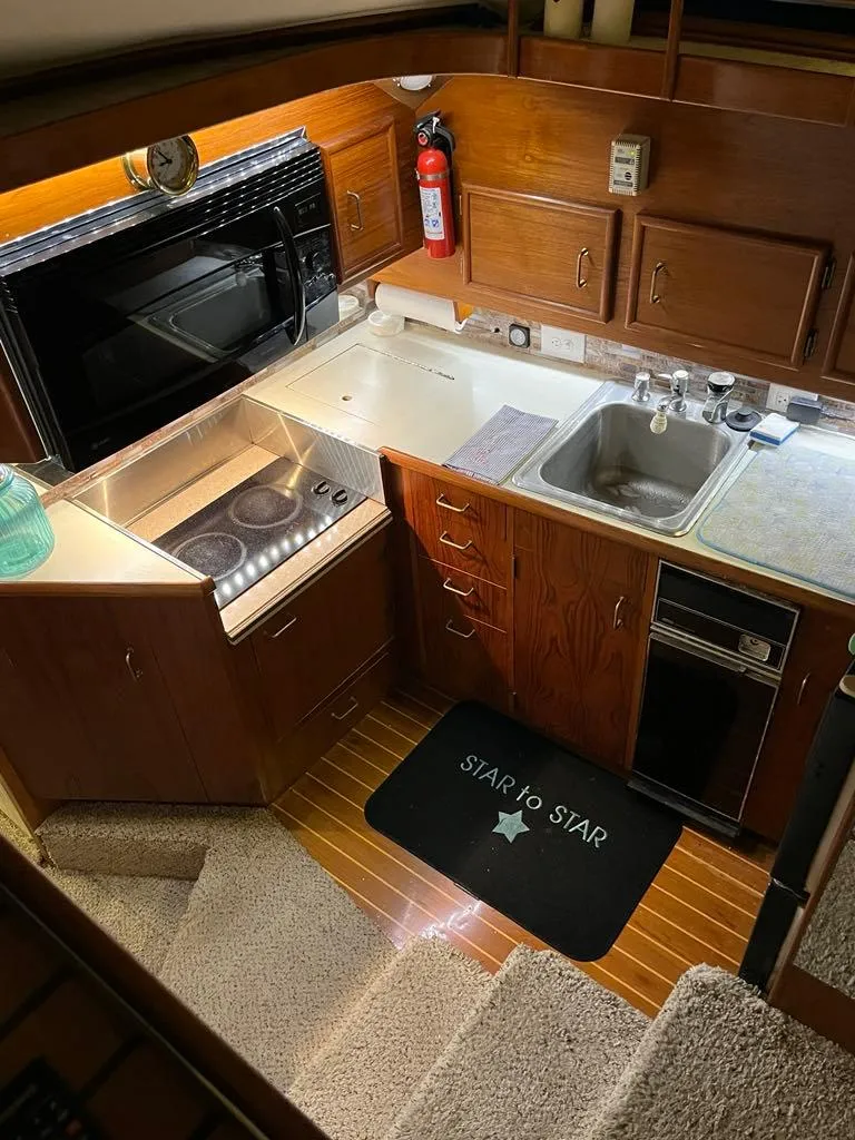 Slide: The Image of 1989 Ocean Yachts 44 Super Sport Custom kitchen with wood cabinetry and modern appliances. - 11