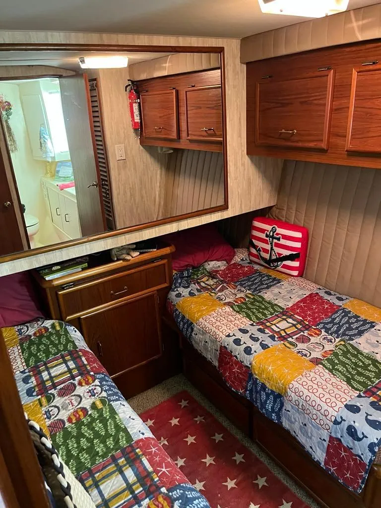 Slide: The Image of 1989 Ocean Yachts 44 Super Sport Custom cabin with twin beds and nautical decor. - 12