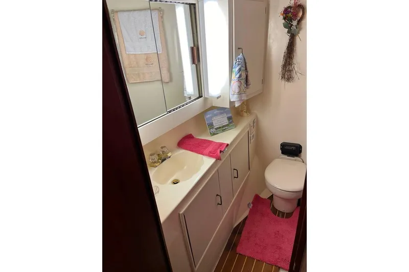 Slide: The Image of Bathroom interior of 1989 Ocean Yachts 44 Super Sport Custom, featuring sink and toilet. - 14