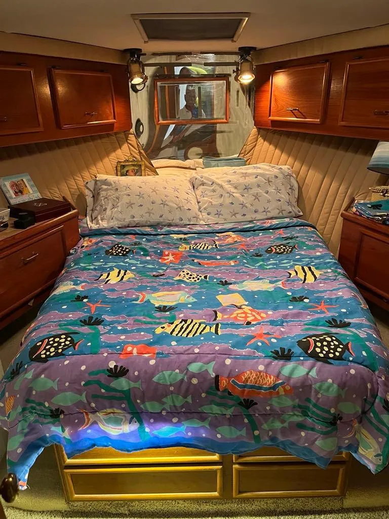 Slide: The Image of Cozy bedroom in 1989 Ocean Yachts 44 Super Sport Custom with nautical-themed bedding. - 15