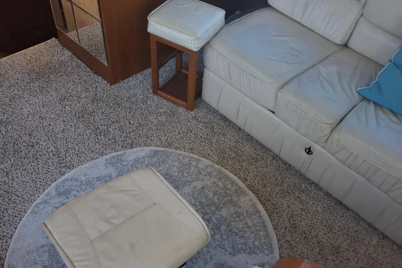 Slide: The Image of Interior of 1989 Ocean Yachts 44 Super Sport Custom with beige sofa and carpet. - 20