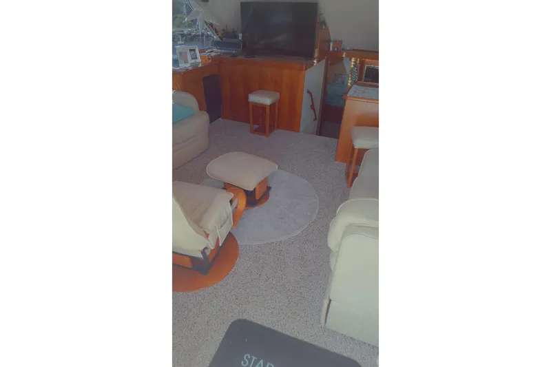 Slide: The Image of Interior of 1989 Ocean Yachts 44 Super Sport Custom, featuring cozy seating and a TV. - 21