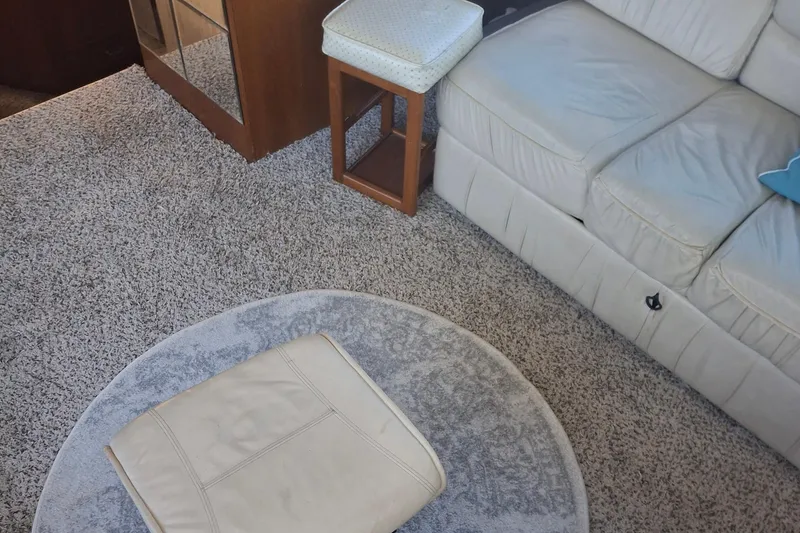 Slide: The Image of Interior of 1989 Ocean Yachts 44 Super Sport Custom with beige sofa and carpet. - 22