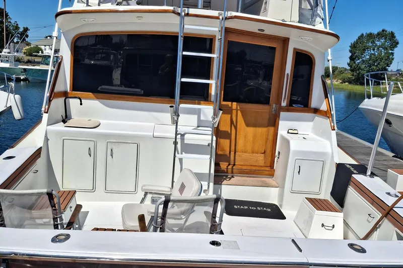 Slide: The Image of 1989 Ocean Yachts 44 Super Sport Custom boat deck with seating and ladder. - 23