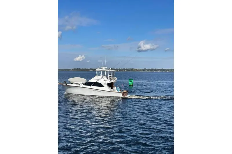 Slide: The Image of 1989 Ocean Yachts 44 Super Sport Custom cruising on a calm blue sea. - 25