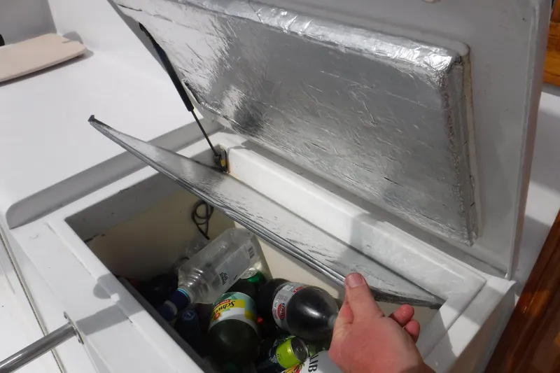 Slide: The Image of Cooler compartment on 1989 Ocean Yachts 44 Super Sport Custom, stocked with beverages. - 26