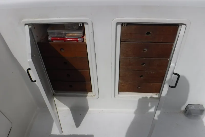 Slide: The Image of Storage compartments on 1989 Ocean Yachts 44 Super Sport Custom boat with wooden drawers. - 27