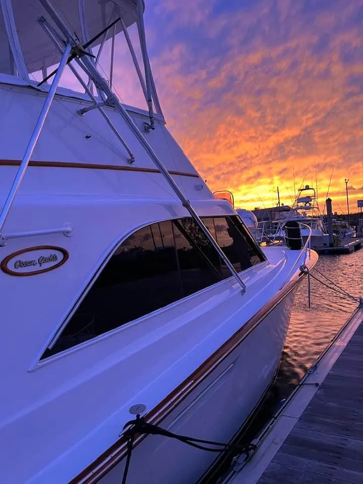 Slide: The Image of 1989 Ocean Yachts 44 Super Sport Custom at sunset in marina. - 3