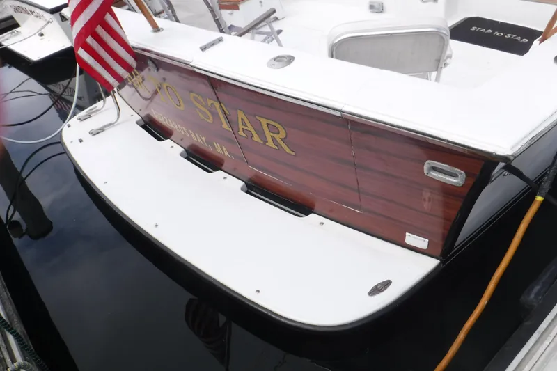 Slide: The Image of 1989 Ocean Yachts 44 Super Sport Custom docked, featuring wooden transom and American flag. - 30