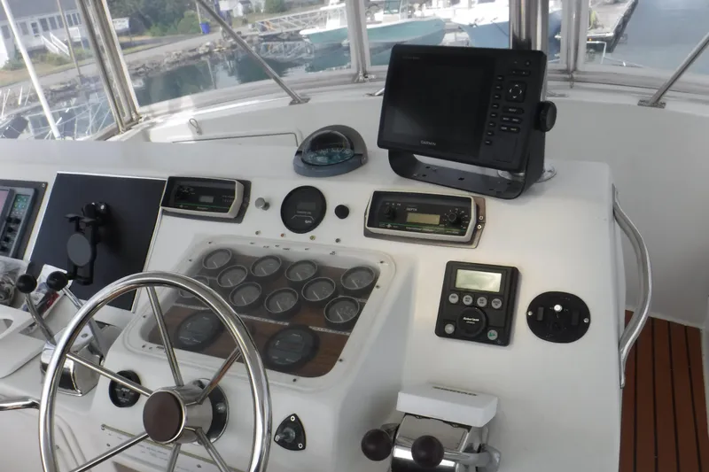 Slide: The Image of 1989 Ocean Yachts 44 Super Sport Custom helm with navigation instruments and steering wheel. - 35