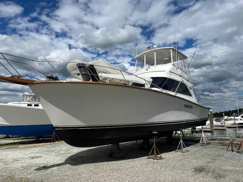 Slide: The Image of 1989 Ocean Yachts 44 Super Sport Custom boat on stands under cloudy sky. - 4