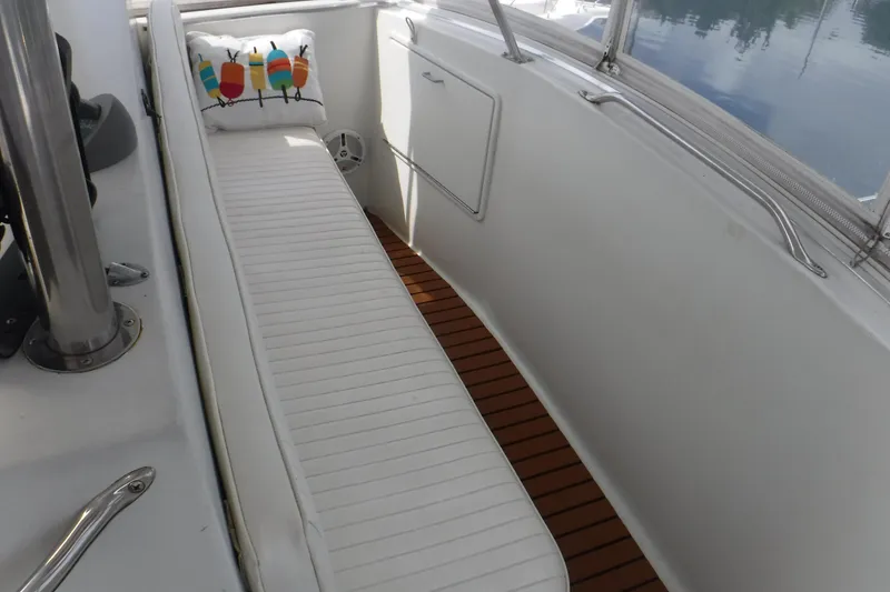 Slide: The Image of 1989 Ocean Yachts 44 Super Sport Custom boat interior with white seating and colorful pillow. - 41