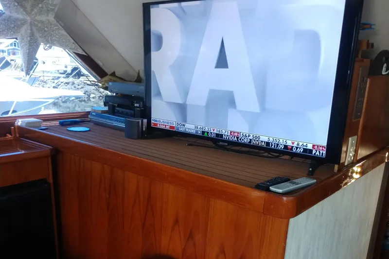 Slide: The Image of 1989 Ocean Yachts 44 Super Sport Custom interior with TV and wooden cabinetry. - 5