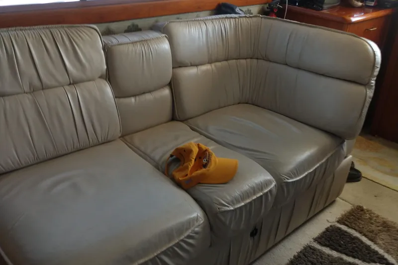 Slide: The Image of Beige leather sofa inside 1989 Ocean Yachts 44 Super Sport Custom, with a yellow cap on it. - 6