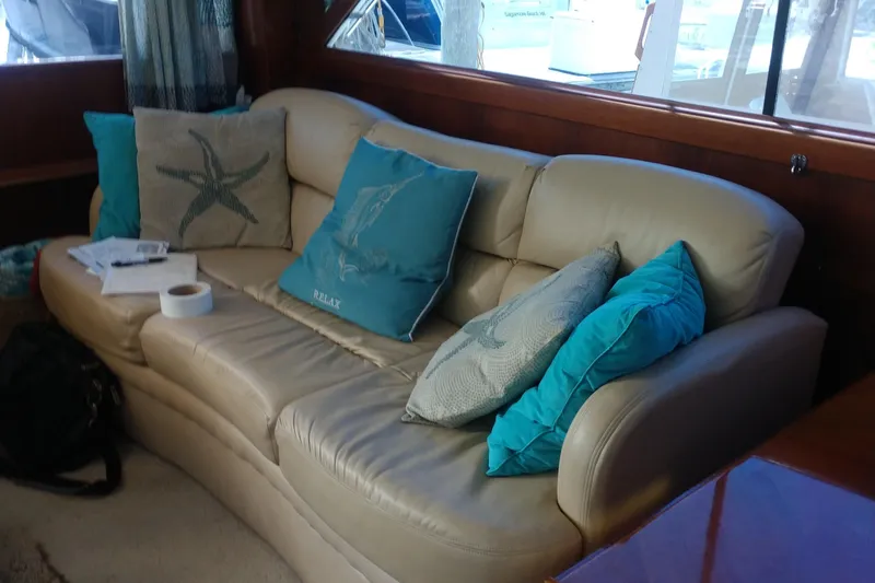 Slide: The Image of Luxurious interior of 1989 Ocean Yachts 44 Super Sport with beige leather sofa and teal cushions. - 7