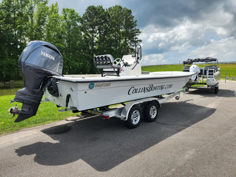 Slide: The Image of 2025 May-Craft 22 Hancock Edition boat on trailer with Yamaha outboard motor. - 2