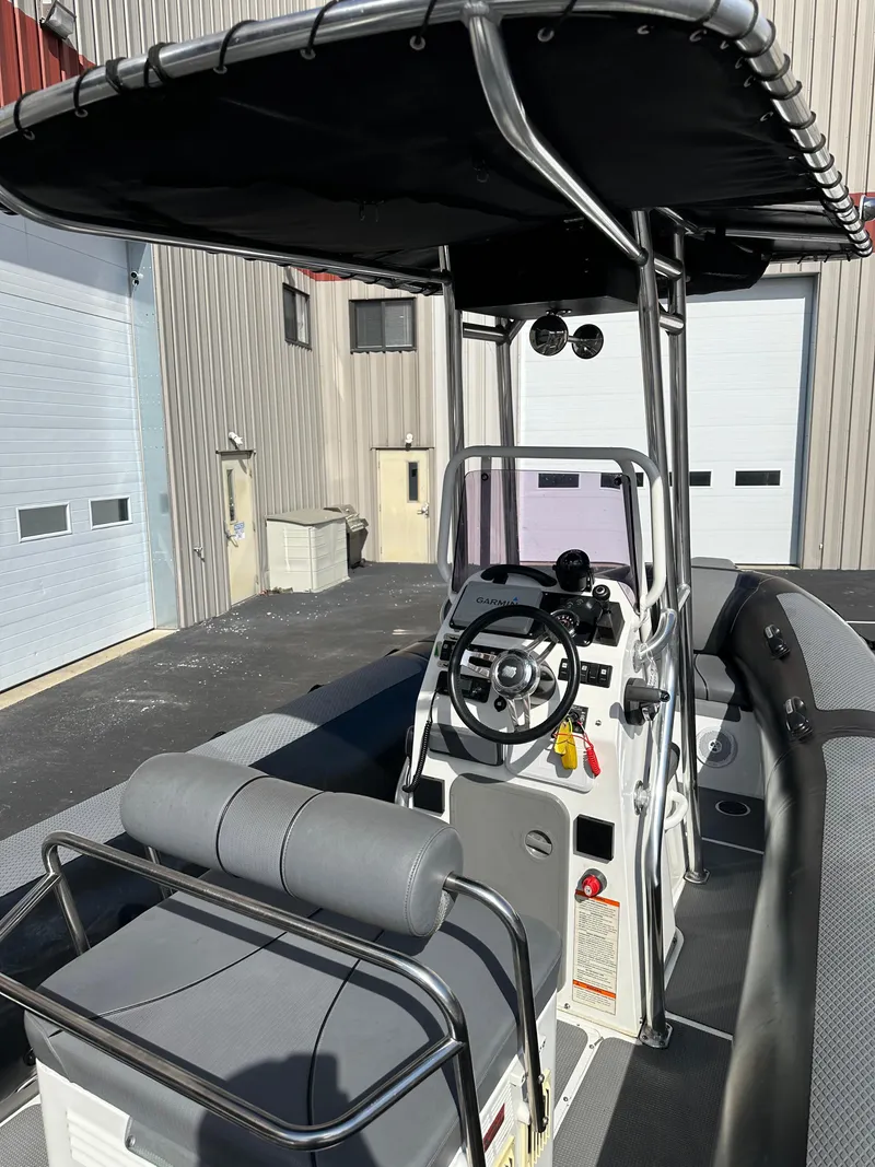 Slide: The Image of 2013 Sealegs 7.1m RIB with T-top and console in a marina. - 10