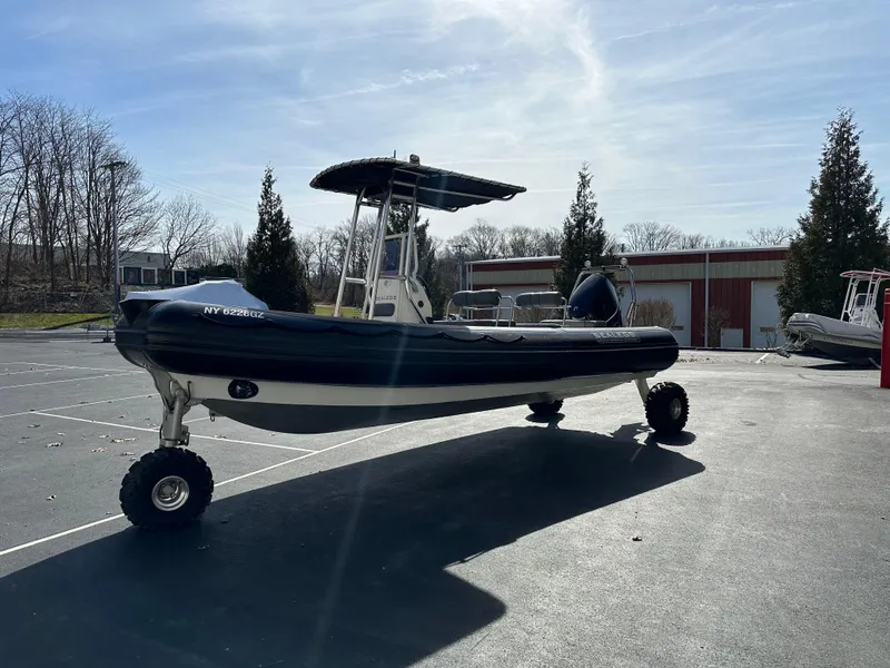 Slide: The Image of 2013 Sealegs 7.1m RIB amphibious boat with wheels, parked on asphalt. - 3