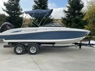 Slide: The Image of 2024 Tahoe 210 S boat on trailer with blue and white exterior. - 0