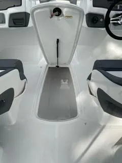 Slide: The Image of 2024 Tahoe 210 S boat interior with seating and storage compartment. - 5