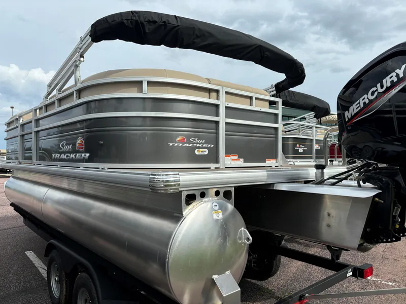 Slide: The Image of 2024 Sun Tracker Party Barge 20 DLX pontoon boat on trailer, rear view. - 4
